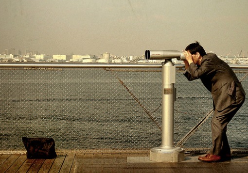 Man looking through binoculars