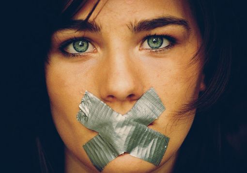 Girl with tape on mouth 