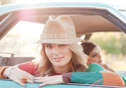 Girl with hat in car.