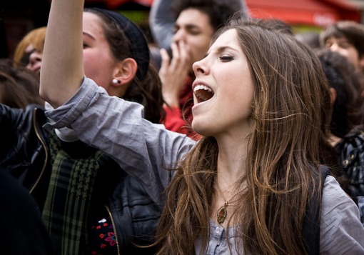 Girl yelling in a crowd
