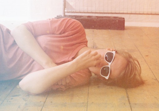 Girl lying on floor with sunglasses | Girl Defined