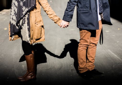 Girl and Guy standing holding hands