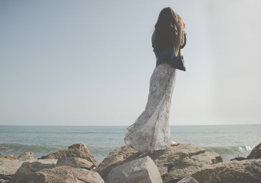 girl standing on rocks