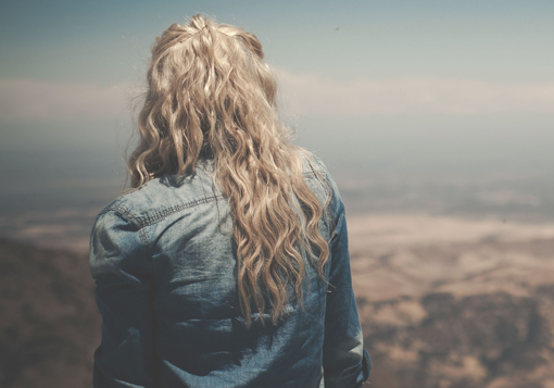 Girl looking over cliff. Girl Defined