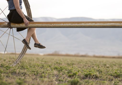 Girl Sitting on Farm Tool