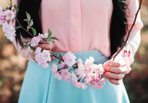 Girl holding flowers. GirlDefined.com