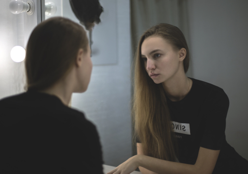 Girl looking in mirror